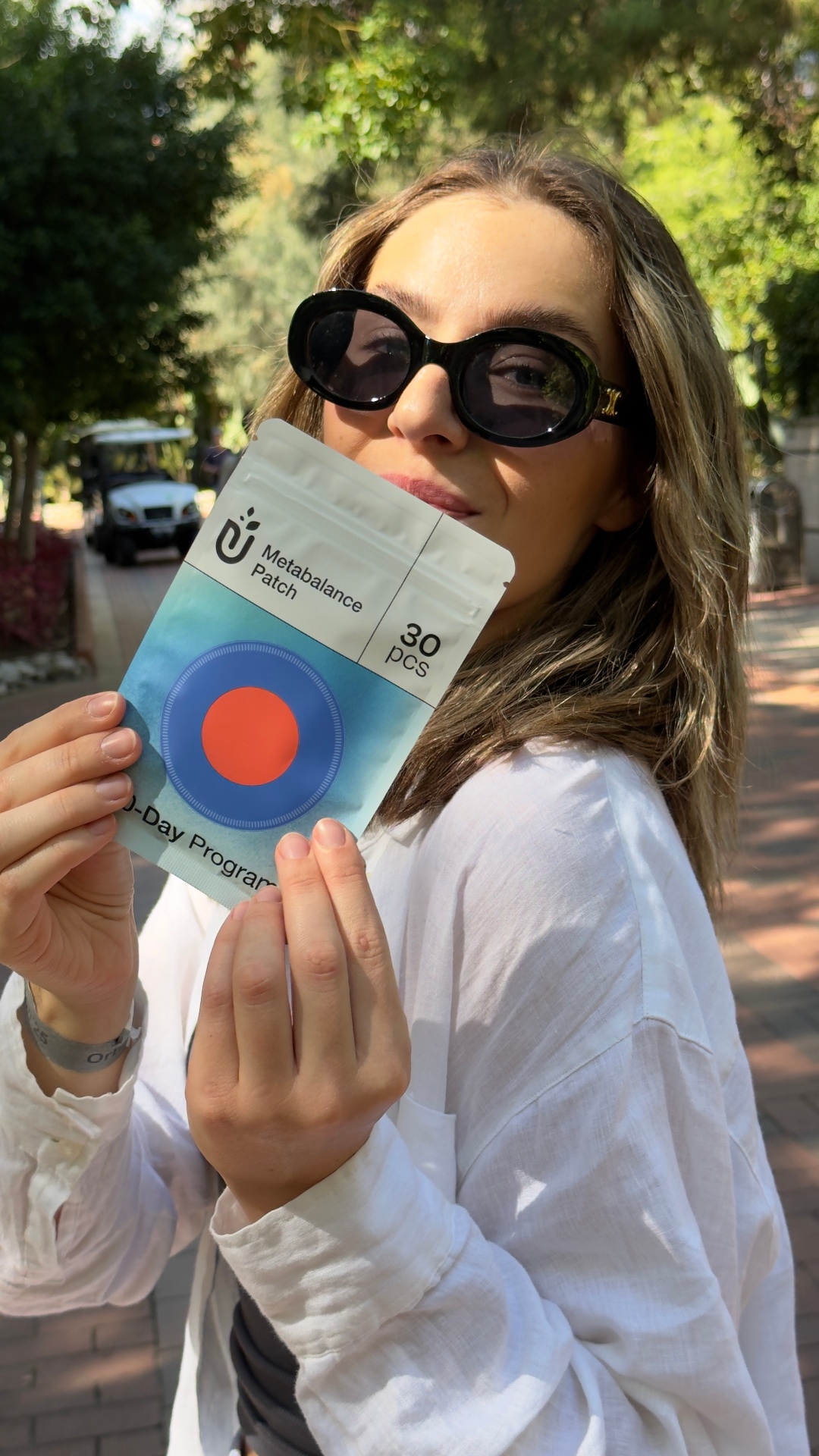 Woman holding a Purisaki Berberine Patch pouch outdoors